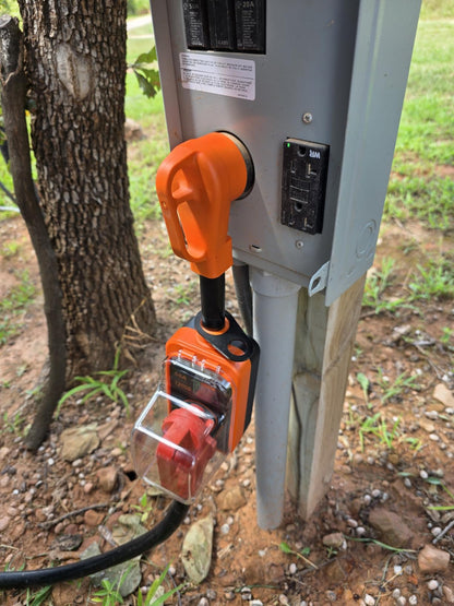 Electric surge protector plugged into a power outlet outdoors
