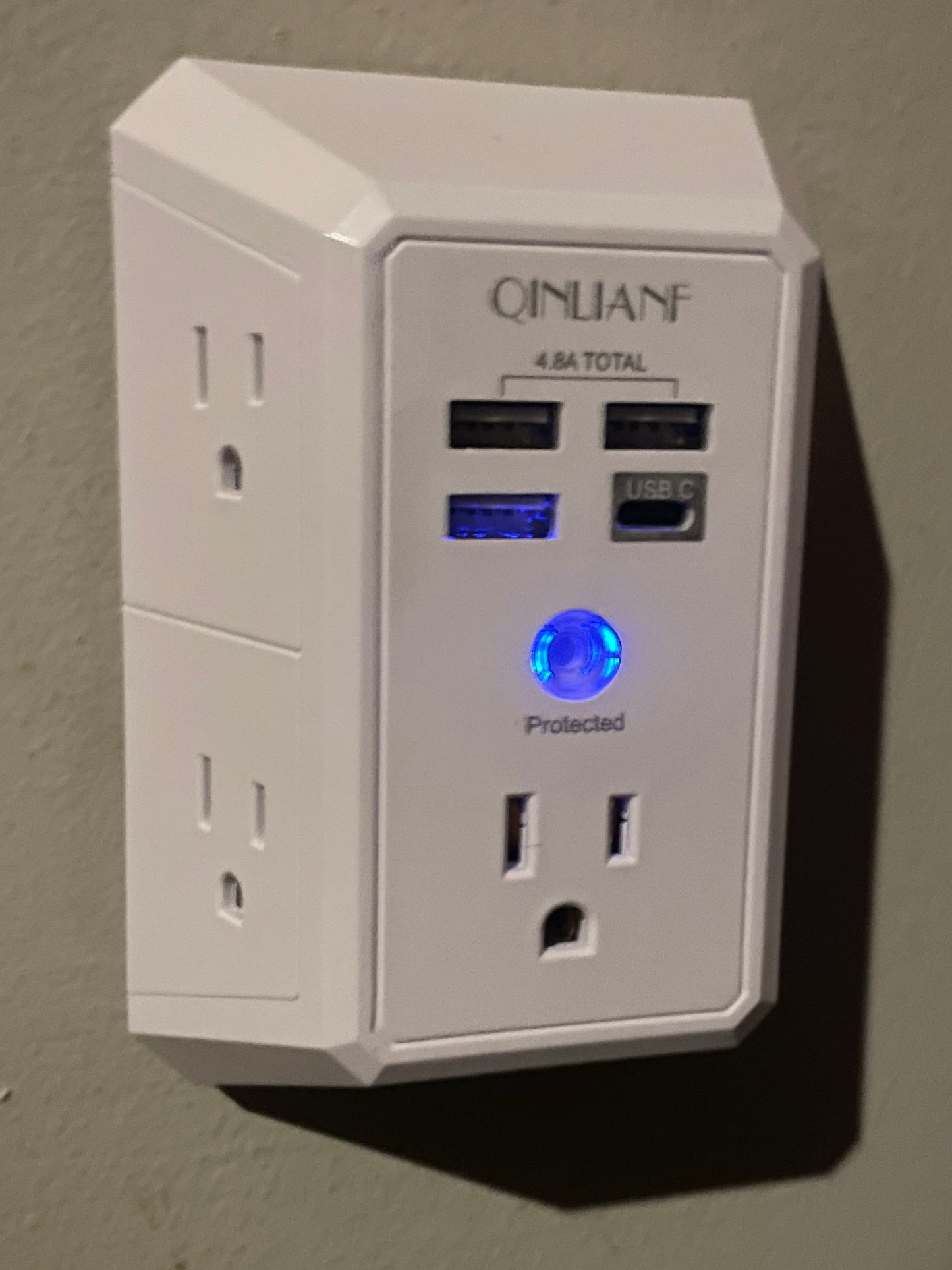 Power strip with multiple outlets and USB ports on a plain background