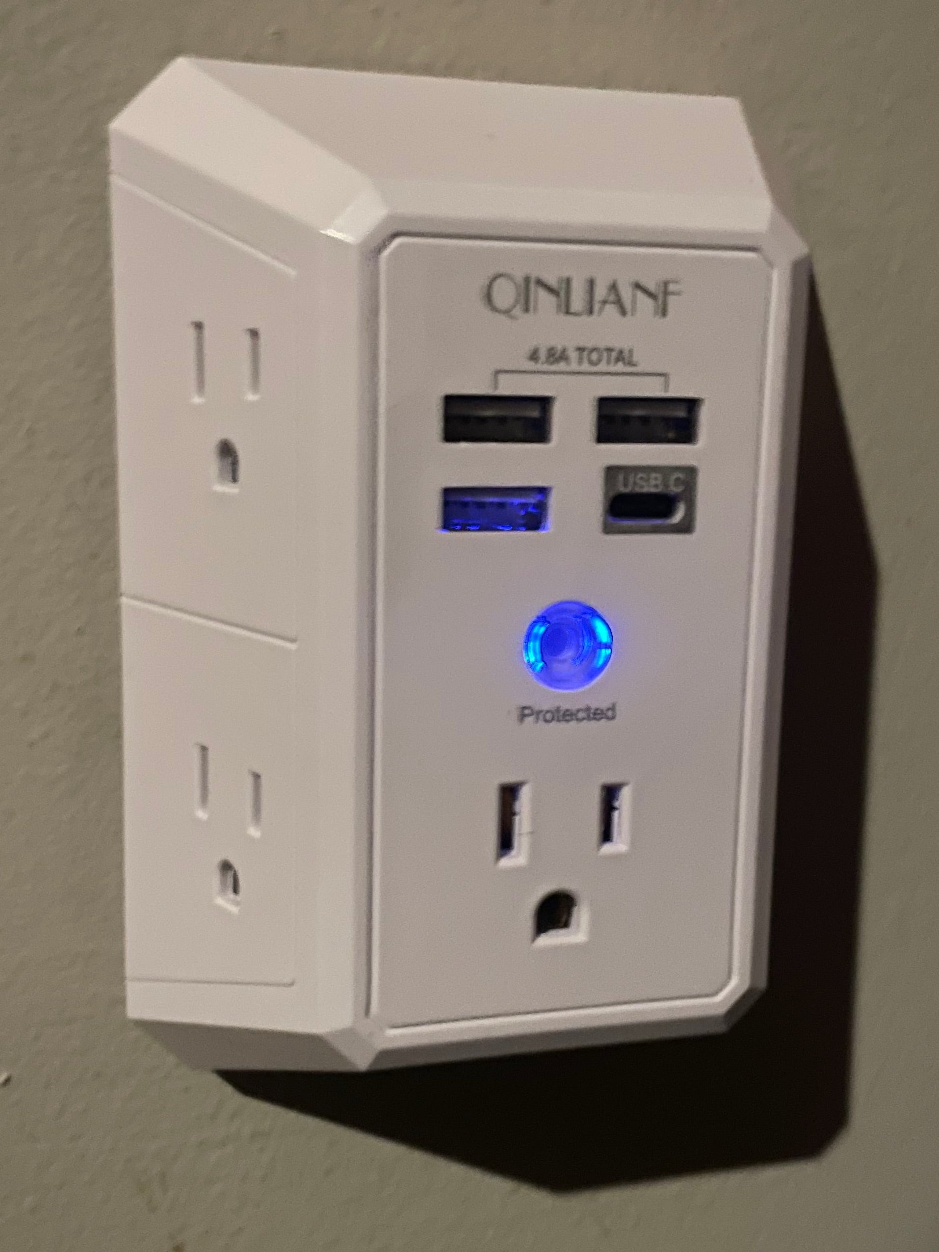 Power strip with multiple outlets and USB ports on a plain background